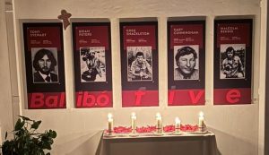 Portraits of the Balibo five, with memorial candles.